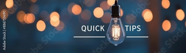 Fototapeta A glowing light bulb with 'Quick Tips' text, against a backdrop of blurred warm lights, conveying ideas and inspiration.