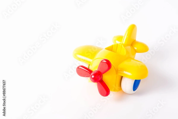 Obraz Yellow Plastic Toy Plane on White Background