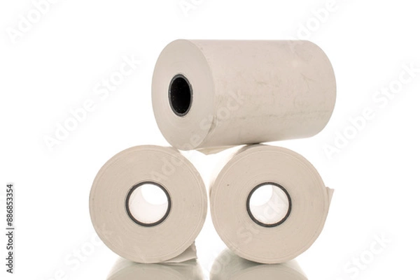 Fototapeta Three rolls of paper cash register tape, close-up isolated on white.