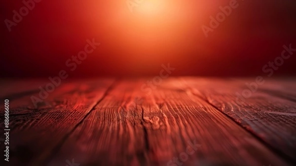 Fototapeta  A tight shot of a wooden table, red light casting in the backdrop, blurred figure in the foreground