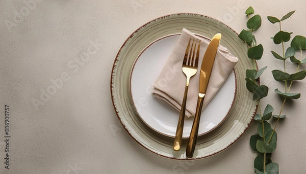 Fototapeta Stylish setting with cutlery, napkin, eucalyptus branch and plates on light table, top view