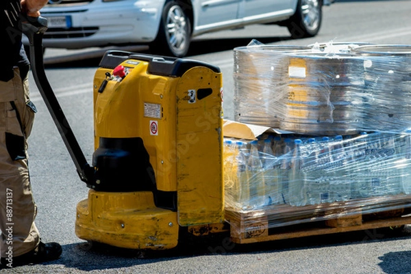 Obraz Carrier moving boxes using a fork lift