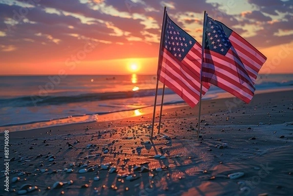 Fototapeta Sharp focus captures the intricate details of the American flags waving in the gentle breeze as the sun sets on a beach, a poignant reminder of Memorial Day.