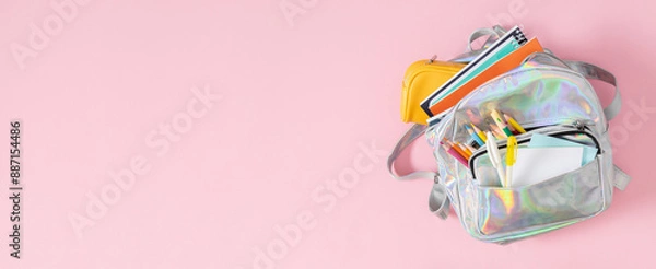 Obraz Backpack with school supplies for study isolated on pink background. Back to school concept. Full school backpack. Flat lay, top view