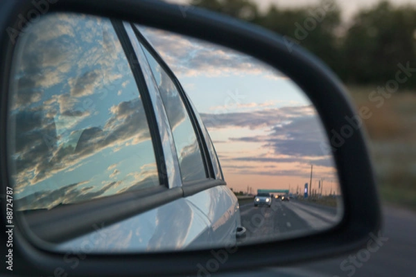 Fototapeta Side view car mirror reflection of sunset