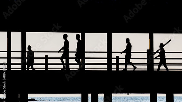 Obraz People walking across the bridge.