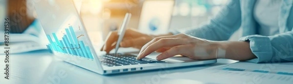 Obraz Close-up of an advisor using a laptop to explain growth metrics to a client, with focus on the hands and charts, leaving room for copy space.