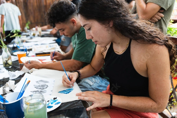 Obraz Group of friends participating in a charitable painting workshop during the summer