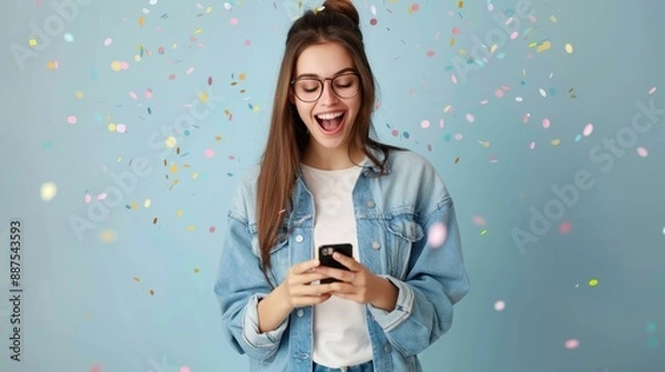 Obraz Happy woman with phone winning prize and confetti shower.