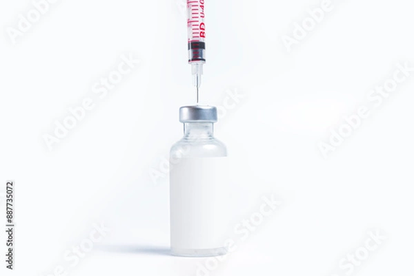 Fototapeta Vaccine bottle with a syringe on a white background
