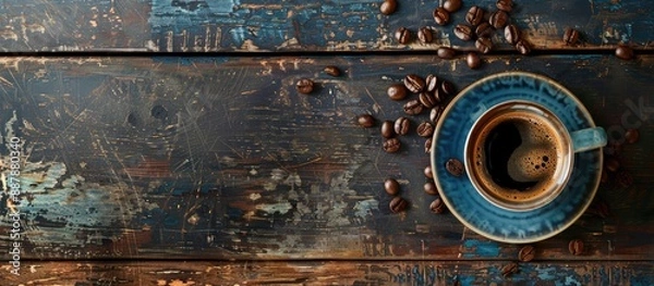 Fototapeta Top down view of a coffee cup beans on a vintage table with space for text or image insertion. with copy space image. Place for adding text or design