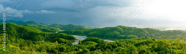 Fototapeta Panorama view from top of the mountain in countryside with lake and big tree of tropical rainforest and sunlight at afternoon. Wonderful springtime landscape in mountains.