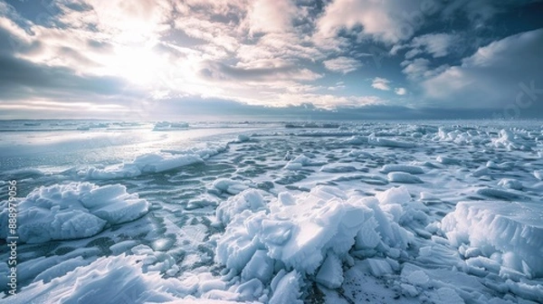 Fototapeta A frozen landscape with a vast body of liquid water covered in ice and snow under a wintry sky An atmospheric phenomenon creating a freezing event on the horizon