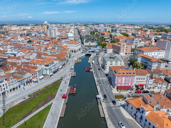 Fototapeta Beautiful aerial view of Aveiro city in Portugal. Aveiro Water canal of Ria de Aveiro with typical boats and tourists, cityscape in the background.