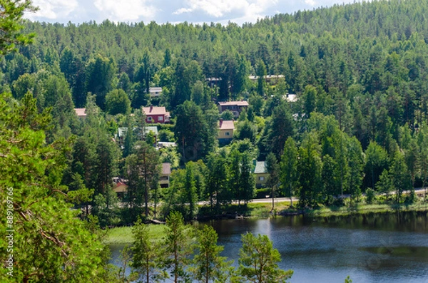 Fototapeta A village build in hillside in Finland. Scenic homes in the Finnish Säynätsalo forest. Nice tourist spot view with lake and clean water. 