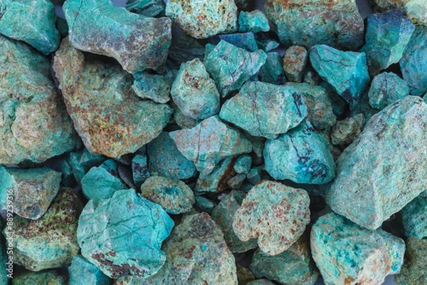 Fototapeta Blue green copper (Cu) oxide ore, held in hand, against background of ore that is out of focus. Mining.