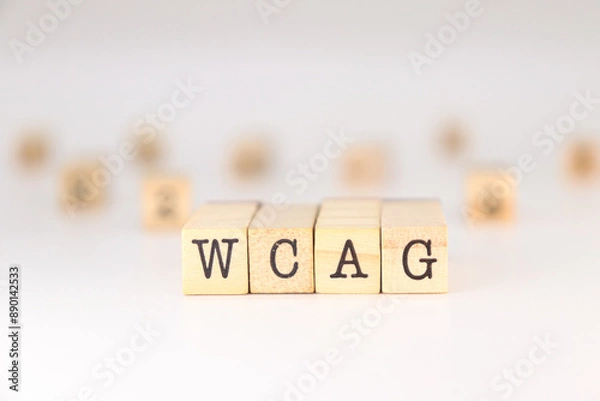 Obraz WCAG acronym - Concept of Web Content Accessibility Guidelines written on wooden cubes isolated on white background with copy space for text phrase.