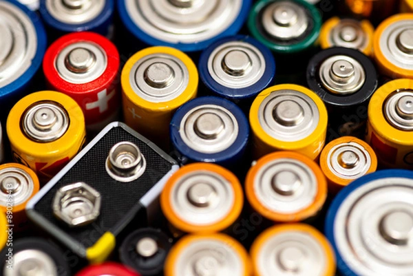 Obraz Background made of various alkaline and lithium-ion batteries, positive pole visible.