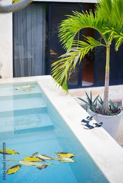 Obraz blue turquoise water of the swimming pool in a yard of the mexican villa in the dusk