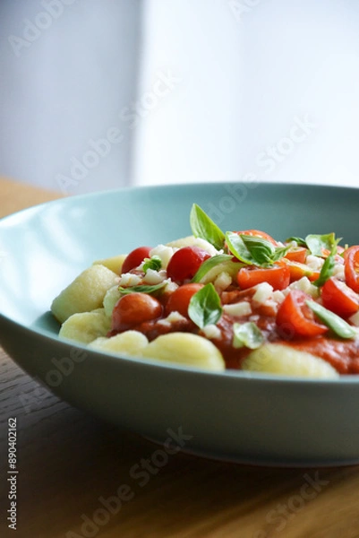 Fototapeta Italian gnocchi with tomato sauce with mozarella and basil on plate 