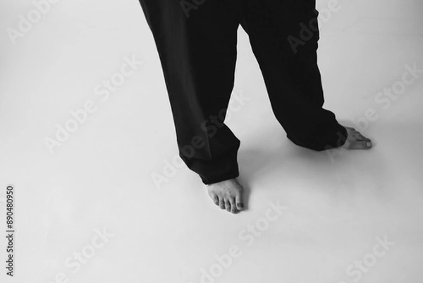 Fototapeta Black and white stylish fashion photography with women's legs. Beautiful female legs in socks or trousers, classic beautiful photo with feet
