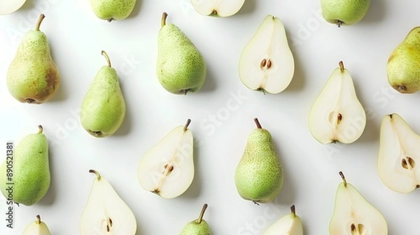 Fototapeta Whole and Sliced Pears Showcasing Smooth Texture and Fresh Green Color on White Background
