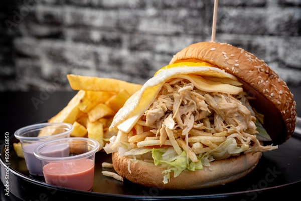 Obraz Delicious shredded chicken sandwich with cheese, egg and chips