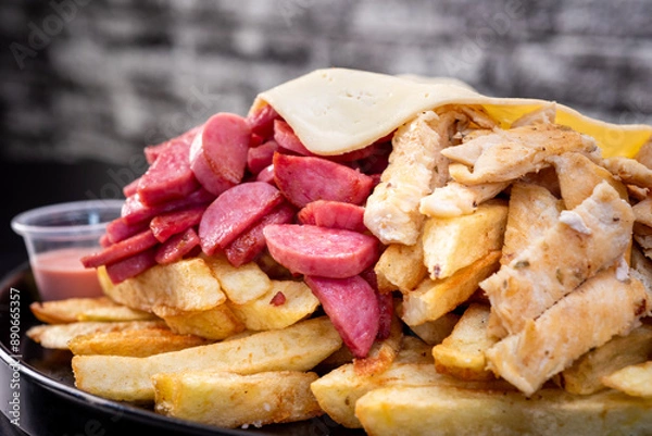 Obraz Peruvian culinary: Salchipapas, a fast food made with fried potatos, sausage, egg, bacon and many sauces like ketchup, mayonaise, mustard and hot pepper and chicken