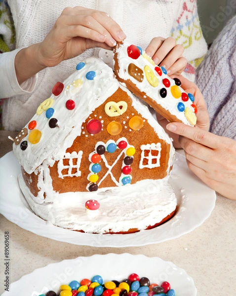 Fototapeta Making Christmas Gingerbread House Together
