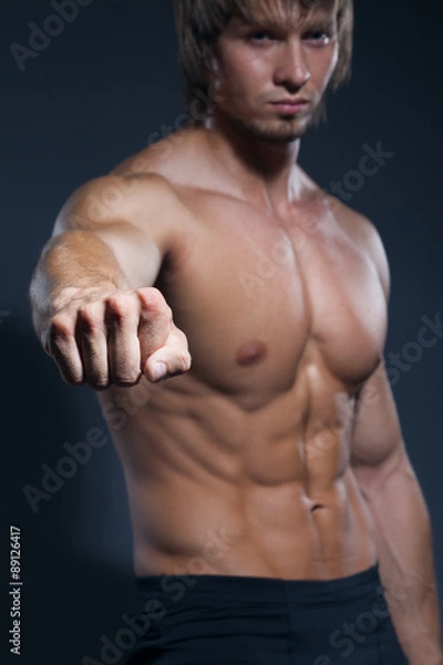 Obraz Bodybuilder showing his back and biceps muscles, personal fitnes