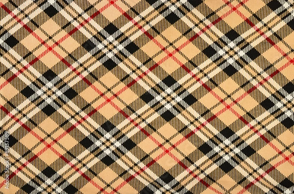 Fototapeta Scottish tartan pattern. Orange with red, white, black plaid print as background. Symmetric rhombus square pattern.