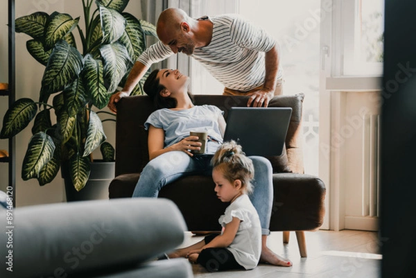 Fototapeta Happy family relaxing at home with technology