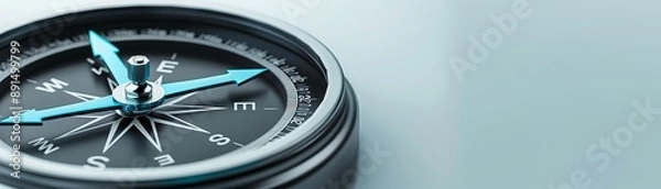 Fototapeta A compass with a blue arrow pointing to the E