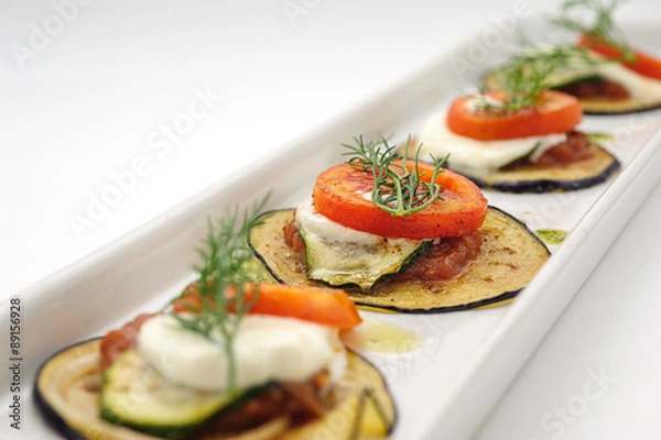 Fototapeta Hot appetizer with fried eggplant isolated on white