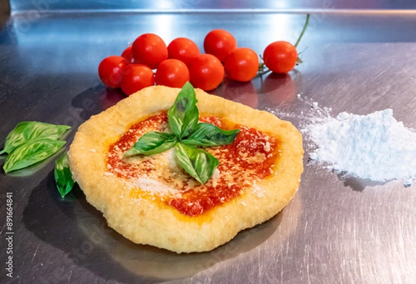 Fototapeta Neapolitan fried pizza with tomato sauce cheese and basil leaves, called Montanara