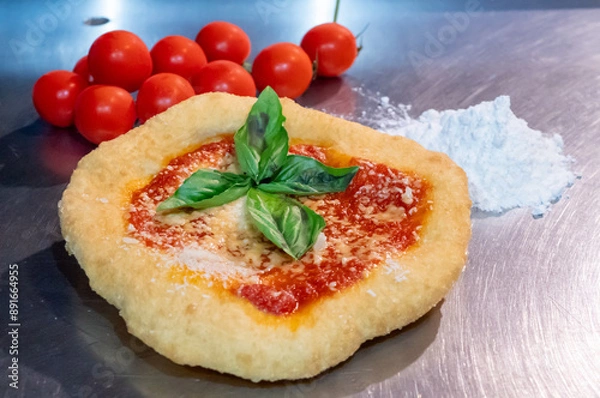 Fototapeta Neapolitan fried pizza with tomato sauce cheese and basil leaves, called Montanara