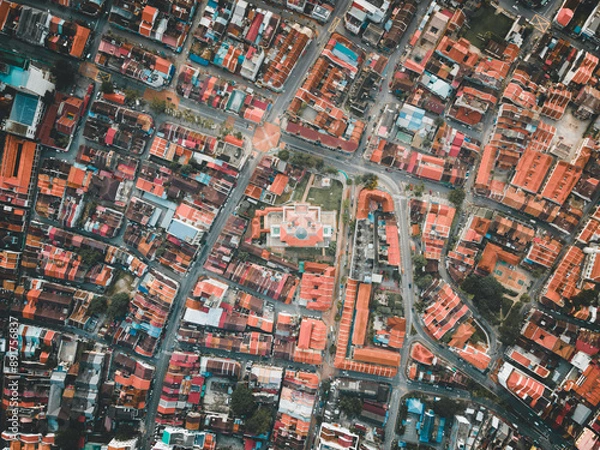 Fototapeta A top-down drone video of Masjid Kapitan Keling in George Town, Penang, reveals the mosque's stunning architecture and its setting within the vibrant UNESCO Heritage Site, multicultural landscape.