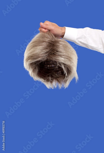 Fototapeta Hand holding a wig