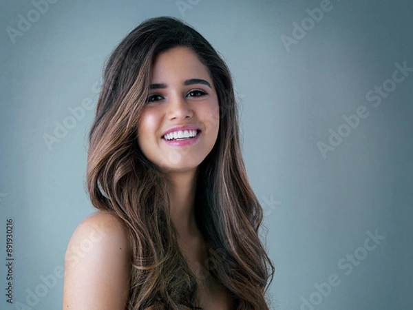 Fototapeta Hair care, portrait and woman in studio with salon, collagen and volume treatment for beauty. Smile, confident and female person with brunette, long and shiny hairstyle by gray background with mockup