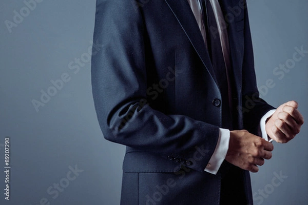 Fototapeta man in suit on a grey background, hands closeup