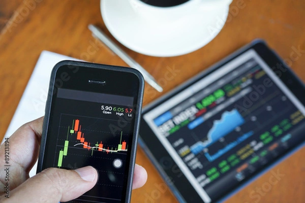 Fototapeta Business man hand hold and touch screen on smart phone,tablet,ce