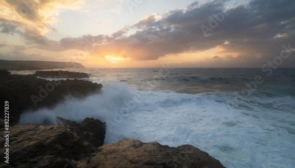 Fototapeta Beautiful colorful sunset and vivid dramatic sky at rocky shore of the Atlantic ocean.