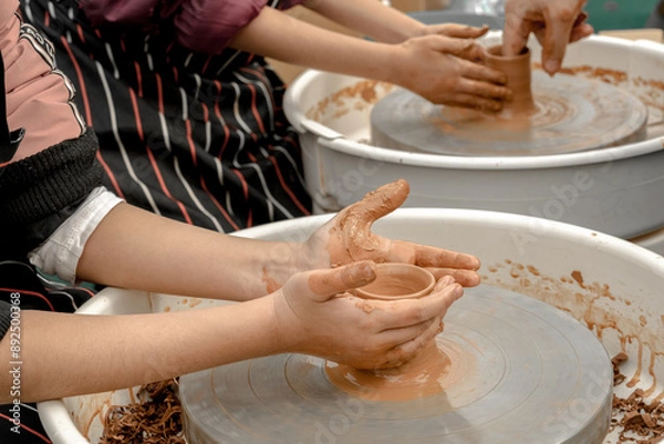 Obraz Master class on clay modeling on a potter's wheel. Craft lessons
