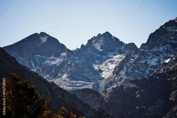 Obraz The majestic Atlas Mountains in Morocco. Snow-capped peaks and rugged terrain under a clear blue sky create a breathtaking, dramatic landscape.