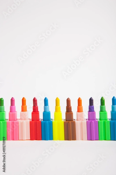 Obraz Multicolored crayons on a white paper background.