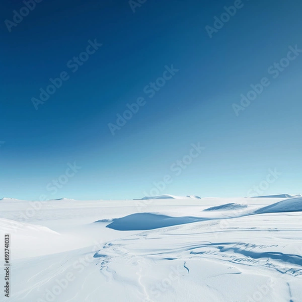 Obraz A landscape covered in snow with a clear blue sky.