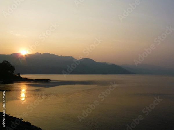 Fototapeta beautiful landscape of mountains on the sea coast at sunset
