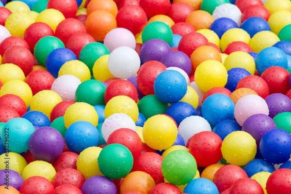 Fototapeta Hundreds of colorful plastic balls on kids playground.