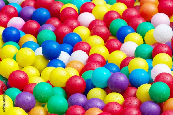 Fototapeta Hundreds of colorful plastic balls on kids playground.