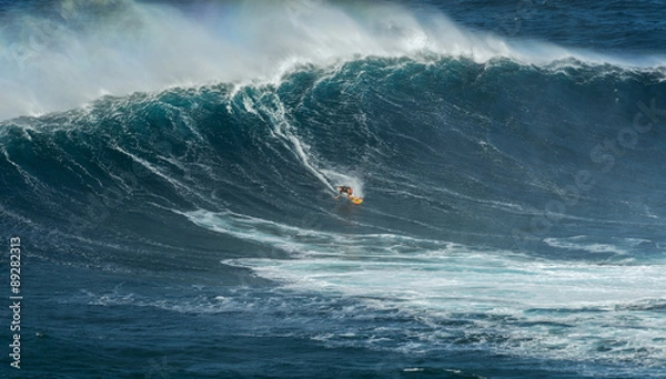 Fototapeta MAUI, HAWAII, USA - DECEMBER 15, 2013: Unknown surfer is riding